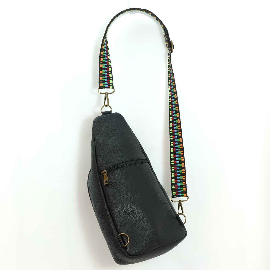 Artisanal leather sling bag in ebony black, back view