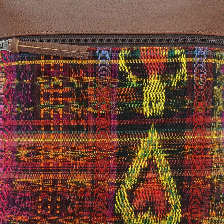 Close-up of a Guatemalan fabric in reds and yellows, used on a crossbody bag
