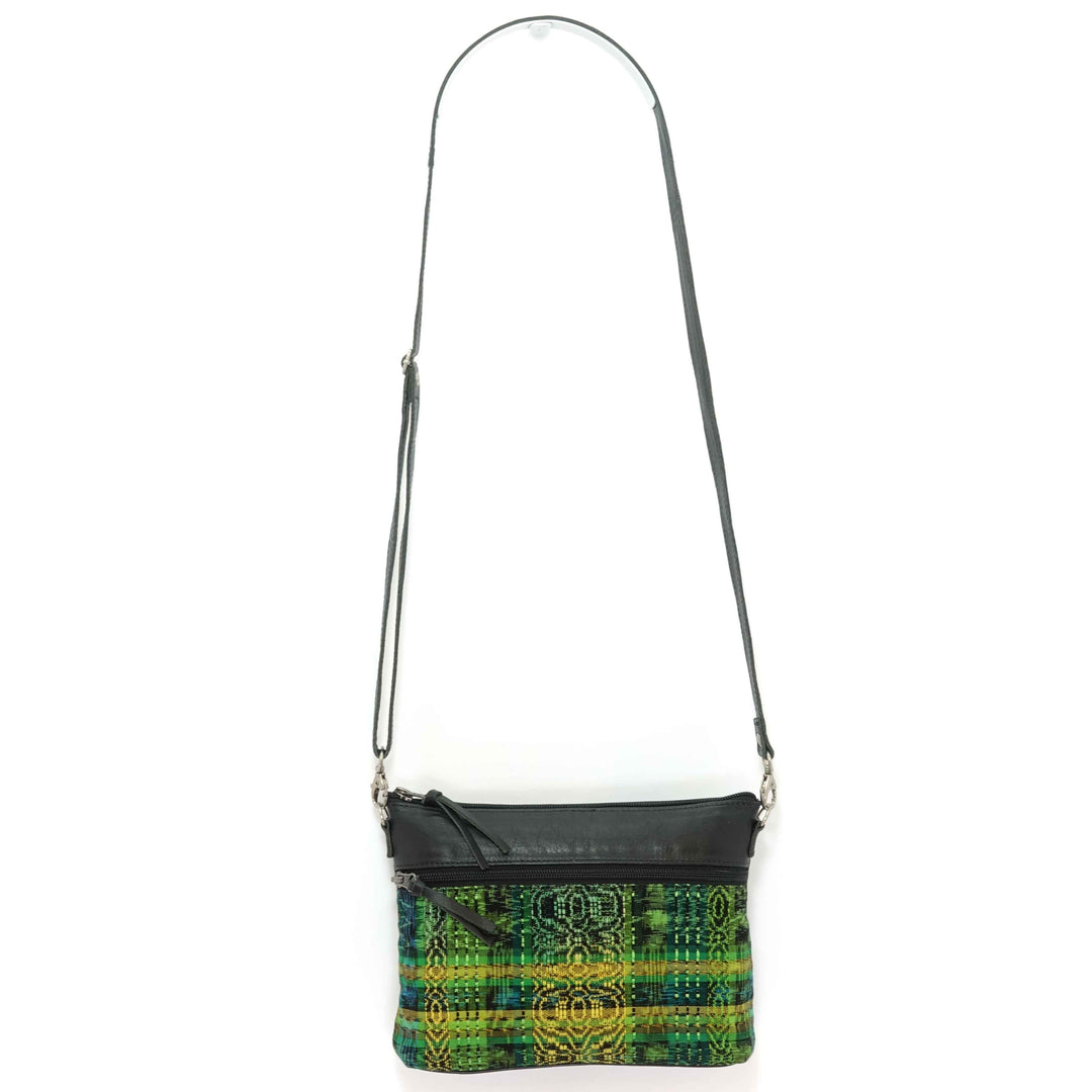 Artisan crafted Guatemalan crossbody bag in a green and yellow pattern with black leather accents