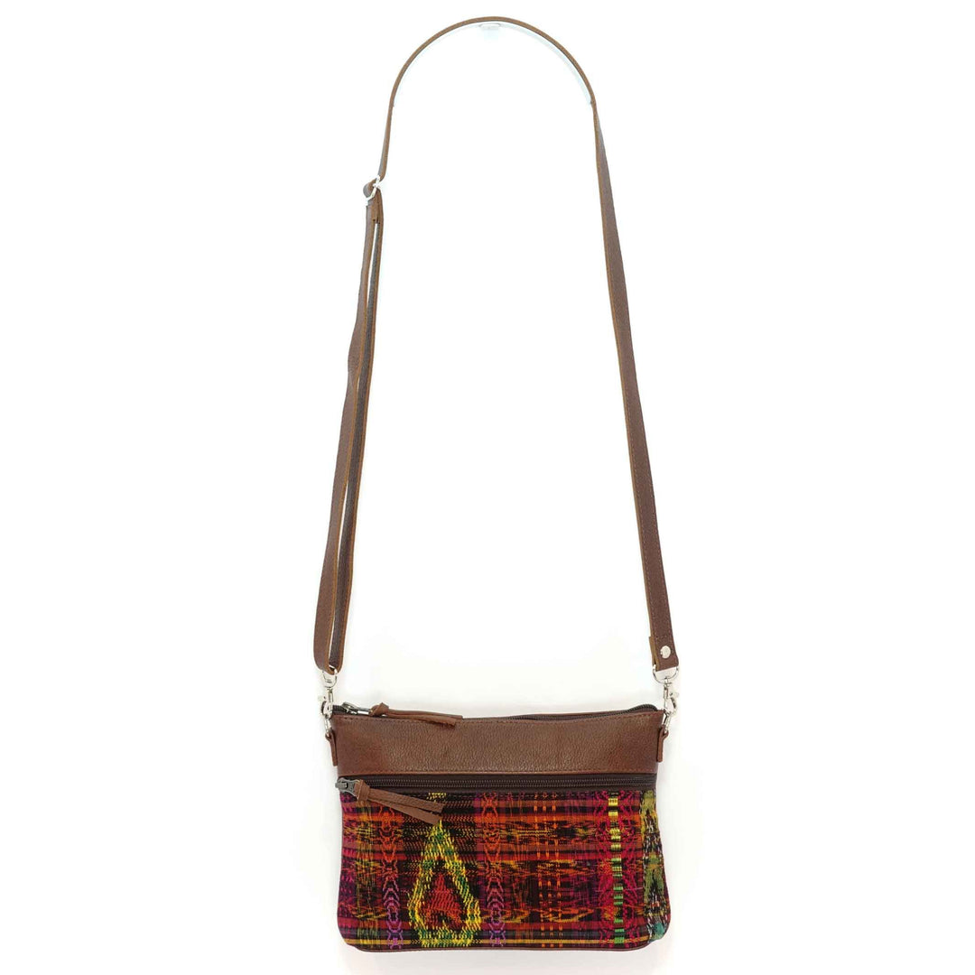 Artisan crafted Guatemalan crossbody in reds and yellows with brown leather accents