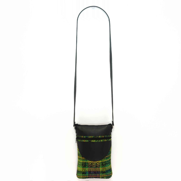 Artisan crafted black leather crossbody, with green and yellow fabric accents