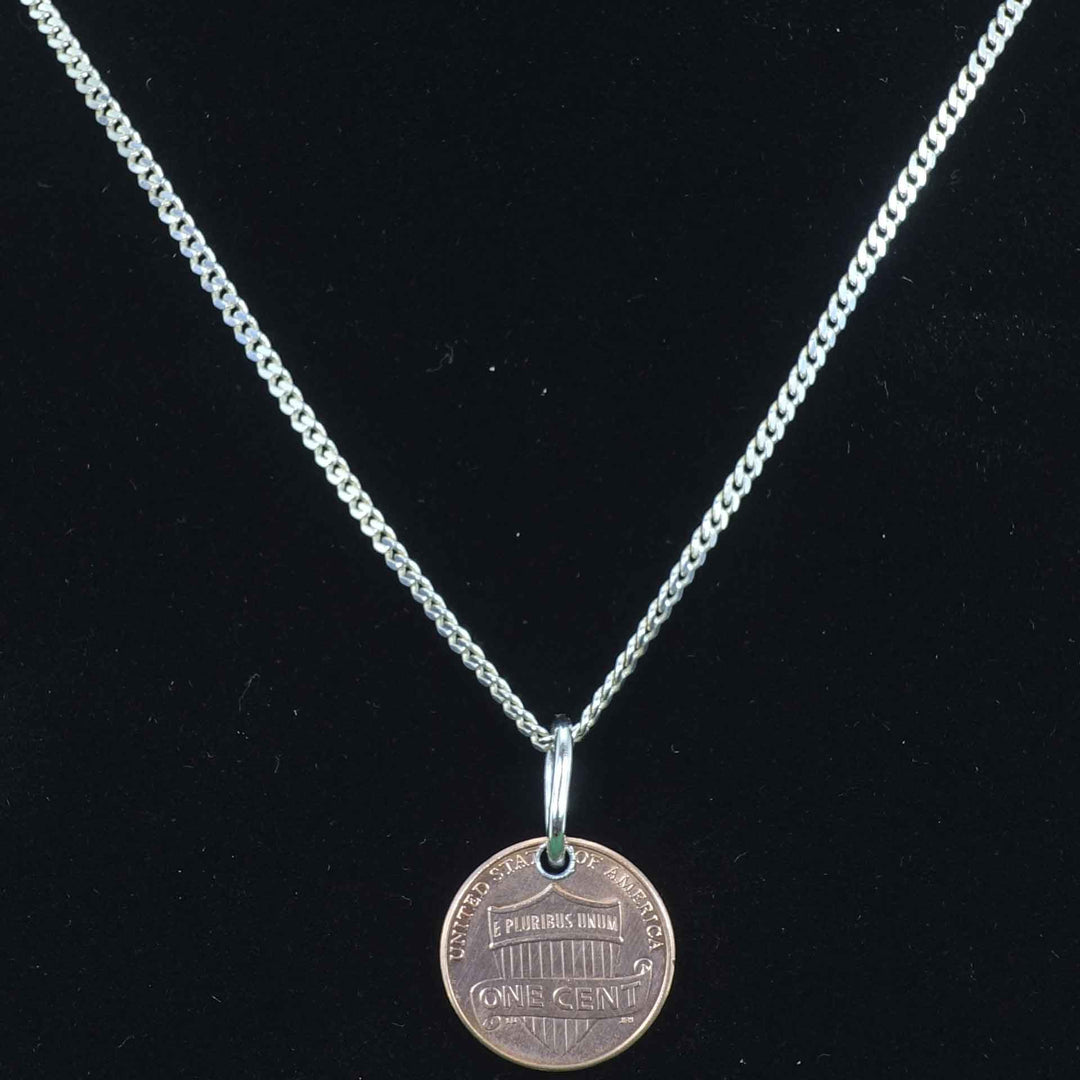 Delicate cuban style sterling-silver-chain with a penny pendant