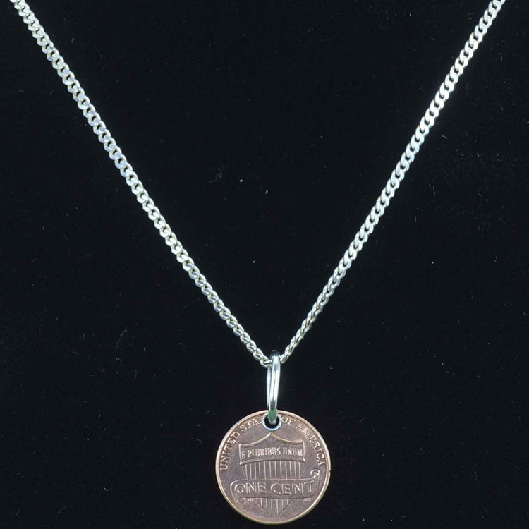 Delicate cuban style sterling-silver-chain with a penny pendant