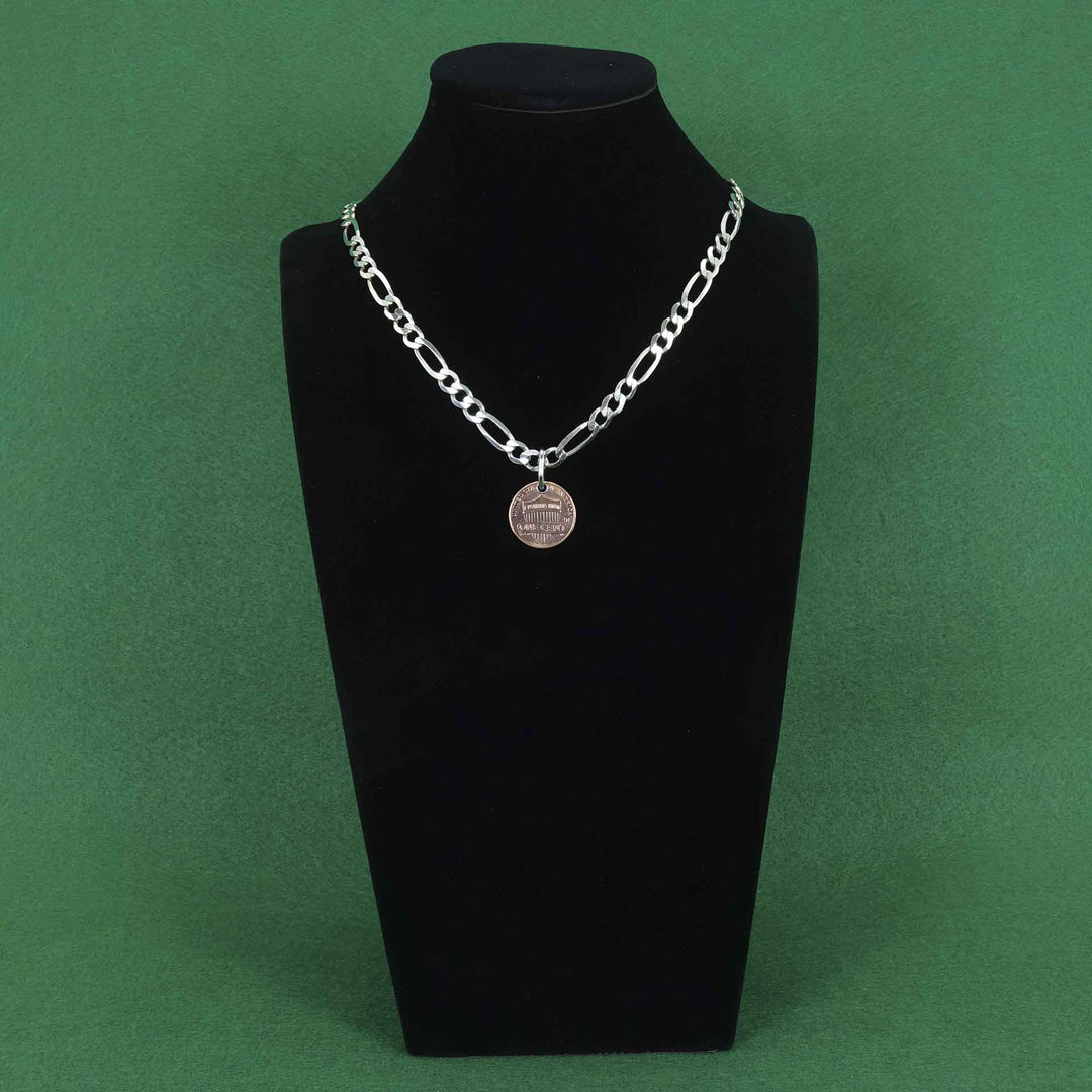 Heavy figaro style sterling silver chain with a penny pendant