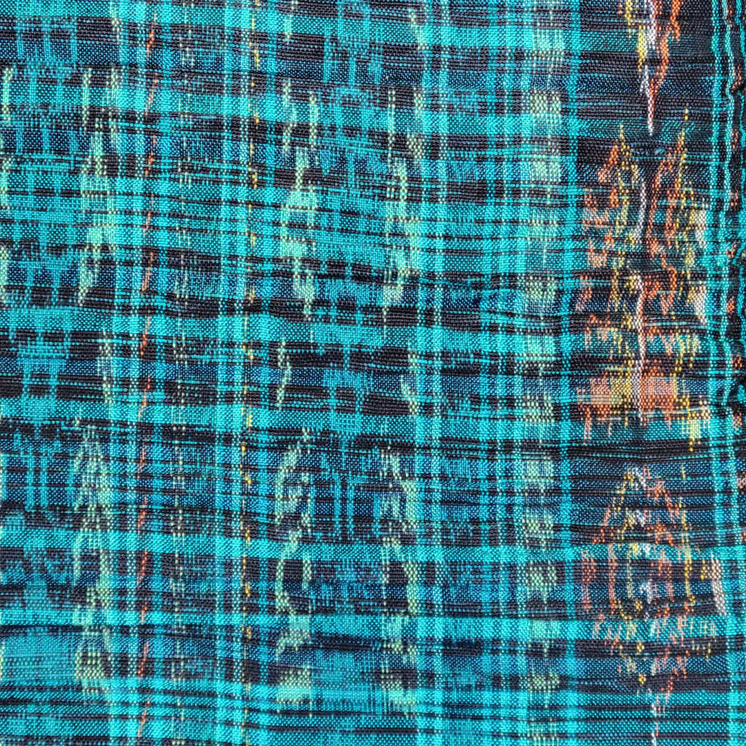 Close-up of a fabric with a plaid pattern in blue, black, and orange.