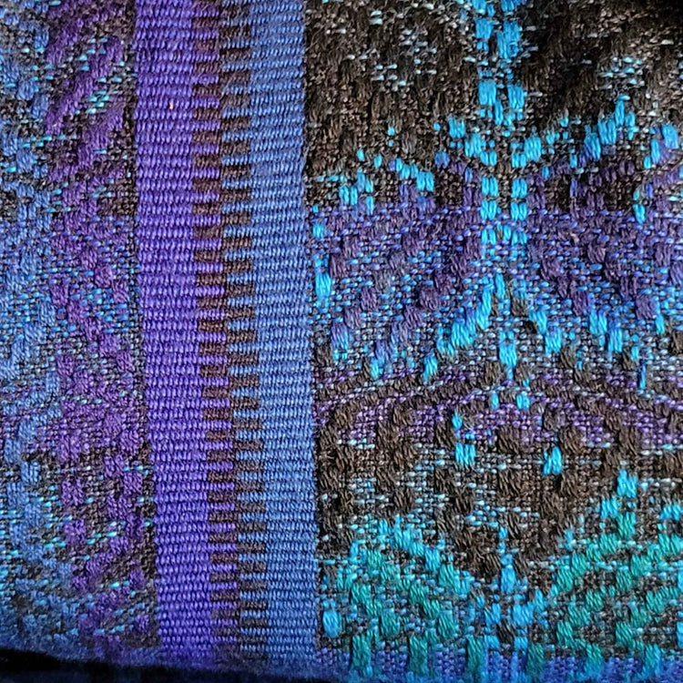 Close up of hand-woven fabric in blues and browns