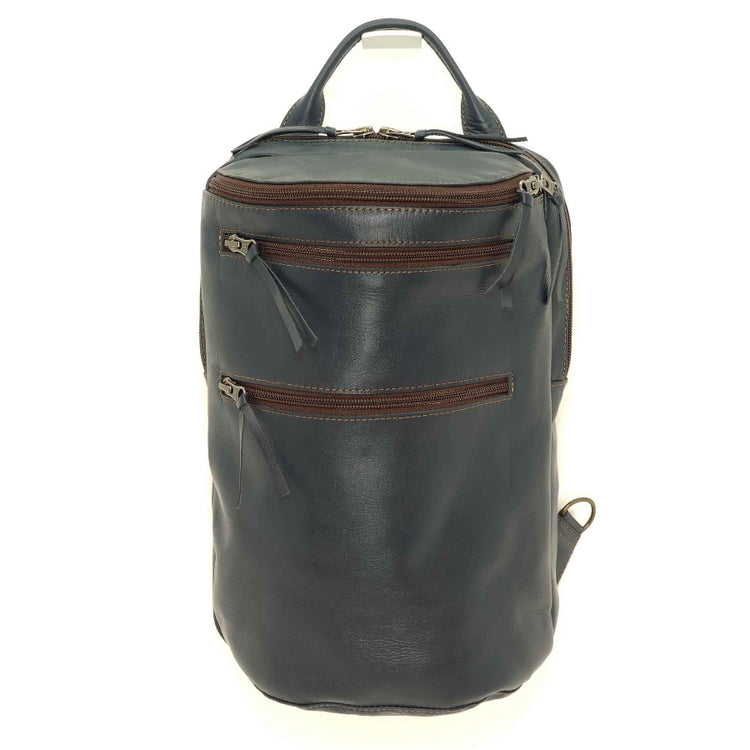 Handmade leather chest pack in an indigo blue with brown accents