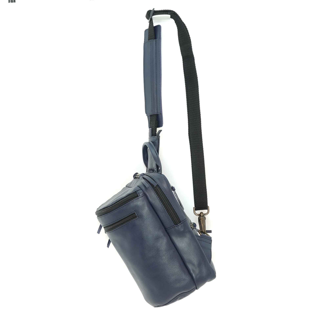 Handmade chest pack in a navy blue leather, side view