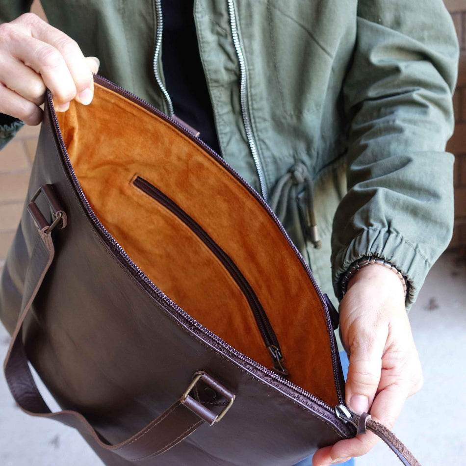 Closeup of a pigskin tote bag liner, held by a person