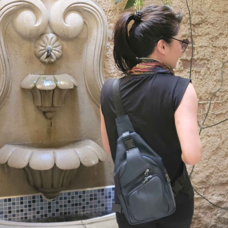 Woman in Guatemala, carrying a leather sling bag in indigo blue